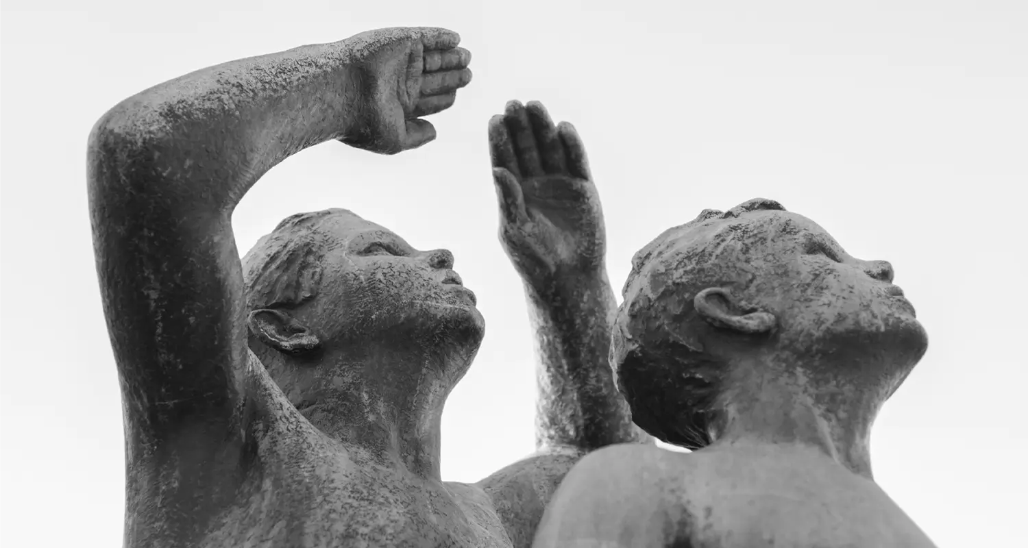 Two sculpted figures reaching upward in the Vigeland installation, Frogner Park Caption: More than 40 years of sketches and revisions went into the figures you walk past in an hour.